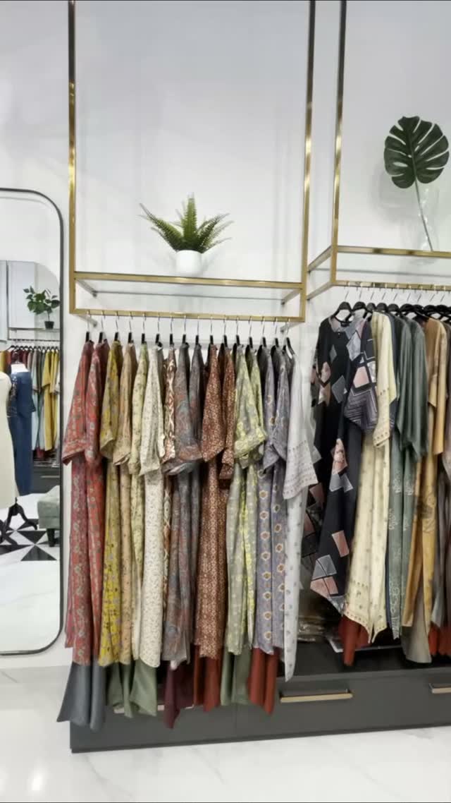 Boutique with gold clothing rails and marble floor